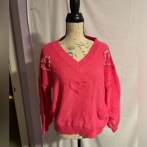 Boutique women’s pink sweater with hearts